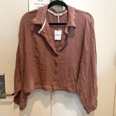 Mauve Colored 100% Cotton Button Down. Flowy Sleeves. Cinching Tie In The Back For Bottom Of Shirt To Give It Different/Fitted Looks Casual Long Sleeve Blouse With Covered Buttons, Casual Fall Shirt With Covered Buttons, Casual Shirt With Covered Buttons For Fall, Spring Casual Tops With Covered Buttons, Casual Spring Tops With Covered Buttons, Spring Loungewear Tops With Button Cuffs, Fall Linen Top With Buttons, Spring Tops With Buttons For Loungewear, Fall Linen Blouse With Button Closure