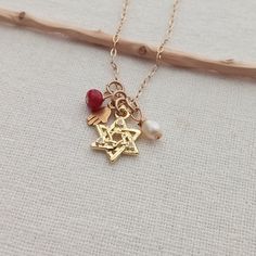 "Jewish necklace. Judaica jewelry. Dainty Magen David pendant. Gold star of David pendant. Women's gift. Jewish gift. 14K Gold filled. Hamsa hand. Protection jewelry Small 14K Gold Filled hamsa hand pendant. Paperclip 14K Gold Filled chain 1 ruby gemstone small bead, 1 freshwater pearl  This necklace measures in length 16\" + 1 inch extender chain You can choose your length! I include always a free surprise gift with every order All items are wrapped individually in a gift box Shipment arrives i Yellow Gold Star Of David Charm Necklace Gift, Yellow Gold Star Of David Charm Necklace, Gold Star Of David Jewelry Gift, Spiritual Necklaces With Star Charm As Gift, Gold Star Of David Charm Necklace For Gift, Gold Star Of David Charm Necklace As Gift, Star Of David Charms Jewelry For Gift, 14k Gold Star Charm Jewelry Gift, 14k Gold Jewelry With Star Charm Gift