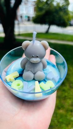 a small toy elephant sitting in a glass bowl