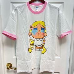 22in Width Under The Armpit 28in Length Shoulder To Bottom 100% Cotton T-Shirt. Super Soft Materials. Popmart Crybaby With Pink Edge Neck And Sleeves. Brand New, Never Worn. Up To 150lb. Only Cold Wash And Air Dry. White Cartoon Print T-shirt For Spring, White T-shirt With Cartoon Print For Spring, Unisex White T-shirt For Spring, Cute White Cotton T-shirt, Kawaii White T-shirt For Summer, White Cotton Kawaii T-shirt, White Graphic Tee With Character Print For Babies, Fun White Unisex Tops, Fun Unisex White Tops