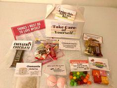 an assortment of candy and candies in a box on a counter top with the words take care yourself written on it