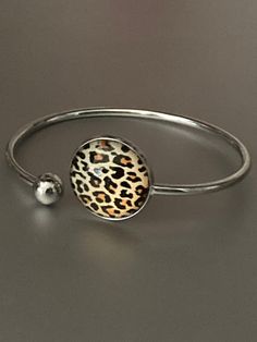 Leopard print stainless steel glass cabochon bangle bracelet    Will not tarnish lightweight to wear I have matching jewellery in this range  necklaces, rings earrings and keyrings :-) just search leopard print !!  Also in other designs Trendy Round Alloy Jewelry, Minimalist Round Alloy Jewelry, Trendy Round Jewelry As Gift, Trendy Silver Circular Jewelry, Trendy Silver Circle Jewelry, Trendy Round Jewelry For Gift, Trendy Stainless Steel Jewelry As Fashion Accessory, Trendy Round Jewelry For Gifts, Gift Alloy Bangle