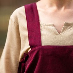 Red Apron Over Dress - Cotton Apron only. Underdress, belt and accessories sold separately. Knee-length apron that is open (and adjustable) on the side. Modeled after a garment artifact found at a Danish Viking trading settlement known as Hedeby. Material: 100% Cotton.Color: Red. Three Sizes: S/ M, L/XL, and 2XL/3XL (see chart) Worldwide shipping available!Custom made to order: Please allow up to 1-3 weeks before item ships. Share: Brown Apron, Red Embroidered Dress, Horns Decor, Beard Beads, Brown Tunic, Green Apron, Red Apron, Viking Dress, Bead Hair Accessories