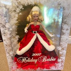 a christmas barbie doll in a box with snowflakes on the floor behind it