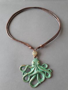 an octopus necklace is hanging from a cord