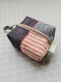 a small zippered pouch sitting on top of a table next to a card holder