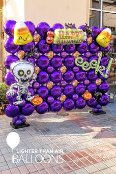 a large purple balloon sign with halloween decorations on it