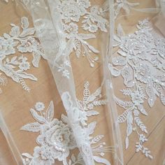 white lace with flowers and leaves on a wooden floor