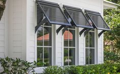 a white house with black shutters on the windows