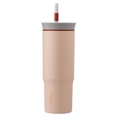 the tumbler cup has a straw sticking out of it's top and is light pink