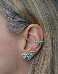 Let your style stand out with this fashion-forward design. The single ear cuff shines with 0.20ct t.w. round cut diamonds & 0.55ct t.w. emeralds. Set in 18K white gold. 18K Gold: 1.6 gr Diamonds: 0.20ct Clarity: VS1 - SI1 Color: G - H Emerald: 0.55ct Dimension: 10mm x 13mm Available in White Gold Natural, untreated gemstones Contact us to further customize SKU: CU0044 Formal Fine Jewelry Cubic Zirconia Ear Cuff, Formal Cubic Zirconia Ear Cuff Fine Jewelry, Three Stone, Round Cut Diamond, Round Cut, Ear Cuff, Fashion Forward, 18k Gold, Emerald