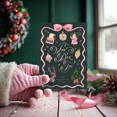 a pink teddy bear next to a christmas card