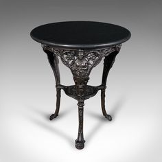 an ornately decorated table with black marble top