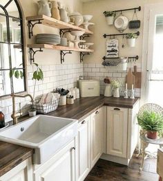 a kitchen filled with lots of white appliances and wooden counter tops next to a window