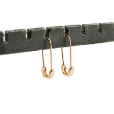 Safety Pin Hoop Earrings | Kris Nations | Wolf & Badger Gift Recycled Gold Tarnish Resistant Hoop Earrings, Gift Tarnish Resistant Recycled Gold Hoop Earrings, Gift Recycled Gold Tarnish-resistant Hoop Earrings, Recycled Gold Huggie Earrings Gift, Recycled Gold Hoop Earring As A Gift, Everyday Safety Pin Single Earring, Gift Safety Pin Shaped Single Earring, Minimalist Safety Pin Jewelry As A Gift, Minimalist Safety Pin Jewelry For Gifts