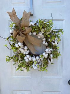 a white door with a wreath on it