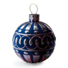 a blue ornament with silver circles and red lights on it's side