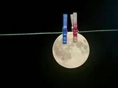 three toothbrushes are hanging on a wire in front of the moon