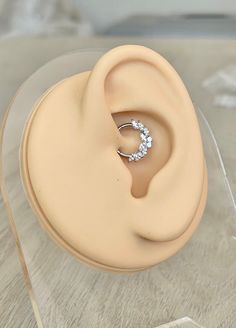 an earring is sitting on top of a plastic stand