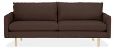 a brown couch sitting on top of a white floor