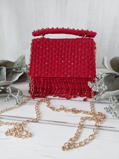 Our best seller for holiday parties, weddings and special occasions!  BREATH TAKING designer clutch with elegant hand embroidery is sure to turn heads! Beautifully embellished with crystal bead work in beautiful tones on a matte RED velvet base. Fully stitched hand embellisments all over. Mini handbag comes with custom crystal beaded top handle and detachable gold chain so can be worn multiple ways! GOLD hardware details. PERFECT clutch sized to fit small accessories in style! Flap opening with Red Beaded Evening Bag For Party, Red Beaded Clutch For Party, Red Handcrafted Evening Bag For Party, Festive Beaded Evening Bag As Gift, Festive Beaded Evening Bag For Gift, Red Embellished Evening Bag For Party, Festive Beaded Evening Bags, Rectangular Evening Bag With Handwork For Party, Glamorous Beaded Clutch As Gift