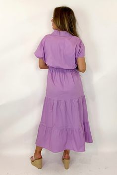 The Gayle Dress By Caryn Lawn is a stunning option for your spring and summer wardrobe! This poplin dress is a one size fits most (recommend for sizes 4-12), features a cross over v-neckline, loose flutter sleeves, an elastic waistline, and tiered midi length. Style this dress for a casual day with sandals or sneaker or dress it up for summer events by pairing with a pair of heels or wedges. Cotton Poplin FITS 4-12 BEST. FITS 5'4 AND TALLER BEST. Purple V-neck Dress With Ruffle Hem, Lavender V-neck Maxi Dress For Spring, Flowy V-neck Midi Dress For Day Out, V-neck Midi Dress With Flowy Skirt For Day Out, Purple Solid Color Midi Dress For Summer, Summer Purple Solid Color Midi Dress, Summer Purple Solid Midi Dress, Purple Dresses For Spring, Purple Solid Color Dress For Spring