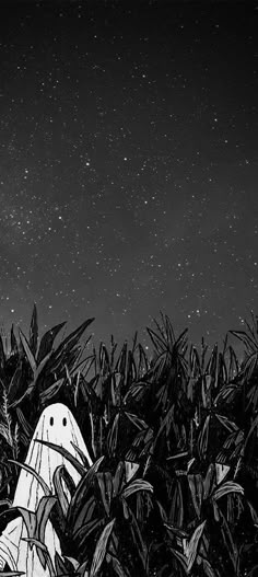 a black and white photo of a scarecrow in the cornfield