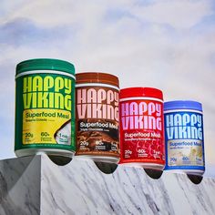 four different flavors of happy viking ice creams on top of a marble block with the sky in the background