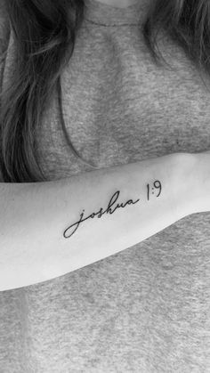 a woman with a tattoo on her arm that reads, joshua 19 1 - 4