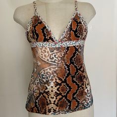 This Gorgeous Wicked Mixed Media Snake And Medallion Print Camisole Is Contrast Trimmed With The Sweetest Posy Printed White Elastic. A Hint Of Metallic Gold Snake Print Overlays Some Of The Fabric. Somehow It Works. Tried On But Never Worn. Have All The Tags But They’re Not Officially Attached. Italian Size 44 Which Is Equivalent To A Us Sz 8 But This Cami Is A Bit Smaller. See Actual Measurements In Comments Below. 90% Nylon 10% Spandex. Made In Serbia And Montenegro. Brown Fitted V-neck Swimwear, Fitted Brown V-neck Swimwear, Brown Fitted Camisole, Fitted Brown Camisole, Brown Stretch Sleeveless Camisole, Fitted V-neck Printed Tank Top, Fitted Printed V-neck Tank Top, Brown Stretch Camisole For Summer, Fitted Brown Camisole With Built-in Bra