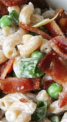 pasta salad with bacon and peas in a white bowl