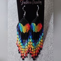 Rainbow Beaded Dangle Earrings Black Beaded Earrings With Round Beads And Fringe, Black Beaded Fringe Earrings With Round Beads, Multicolor Beaded Earrings With Black Beads For Party, Black Beaded Earrings With Ear Wire For Festival, Black Beaded Earrings For Festival, Black Beaded Dangle Chandelier Earrings, Black Beaded Chandelier Earrings, Festival Black Beaded Chandelier Earrings, Black Drop Earrings With Colorful Beads