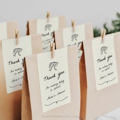 small brown paper bags with thank you notes attached to them