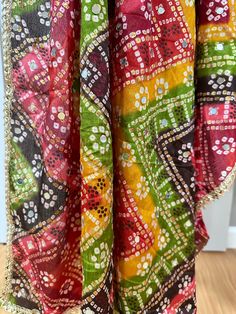 Experience the beauty of traditional Phulkari style with our Multicolor Dupatta. Made with a soft and luxurious silk finish, this dupatta features real mirror accents and stunning designs. Its heavy-weight construction makes it perfect for special occasions like Navaratri. Elevate your wardrobe with this must-have accessory. Approx 2.5 meters length Multicolor Art Silk Anarkali Set With Traditional Drape, Bandhani Print Saree For Festival, Multicolor Mirror Work Anarkali Set In Art Silk, Multicolor Dola Silk Anarkali Set For Traditional Ceremonies, Multicolor Dola Silk Anarkali Set For Festive Occasions, Multicolor Bohemian Sharara With Bandhani Print, Festive Multicolor Anarkali Set In Dola Silk, Festive Multicolor Anarkali Set With Traditional Drape, Bohemian Multicolor Sharara With Bandhani Print