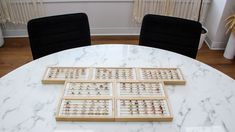 a marble table with four wooden trays on it