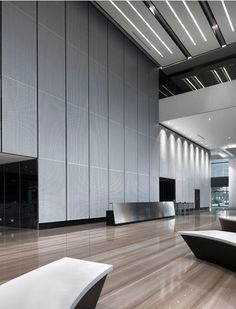 the interior of an office building with wood flooring and white walls, along with modern furniture