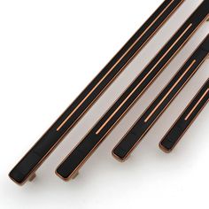 four black and copper handles on a white background