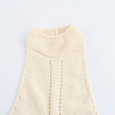 This Halter Neck Slim Fit Knitted Vest is designed to enhance your figure with its flattering slim fit. The halter neck provides added support and a stylish touch. - Color: Beige- Style: Vest- Pattern Type: Solid- Sleeve Length: Sleeveless- Neckline: Halter Neck- Fabric: Knitted- Closure Type: Button- Fit Type: Slim Fit- Occasion: Casual- Gender: Women- Size: S, M, L (Unit: cm)S: Bust: 62 | Length: 54 | Waist: 54M: Bust 66 | Length: 55 | Waist: 58L: Bust 70 | Length: 56 | Waist: 62 Fitted High Neck Beige Sweater, Beige Fitted High Neck Sweater, Beige Stretch Knit Top, Fitted Knit Halter Neck Top, Sleeveless Stretch Crochet Top For Fall, High Neck Knit Top For Summer, Stretch Knit Turtleneck Top, Summer High Neck Knit Top, Fitted Sleeveless Crochet Top For Fall