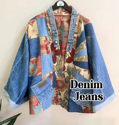 an old jean jacket hanging on a wall with the words denim jeans written below it