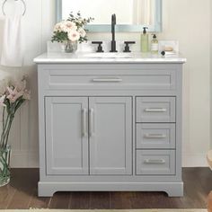 a bathroom vanity with drawers and a mirror