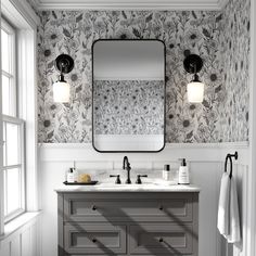 a bathroom vanity with two sinks and a large mirror above it, in front of a window