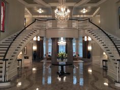 a large foyer with chandelier and marble floors