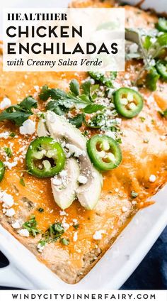 chicken enchiladas with creamy salsa feta in a white casserole dish