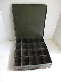 an old metal tool box with compartments in it