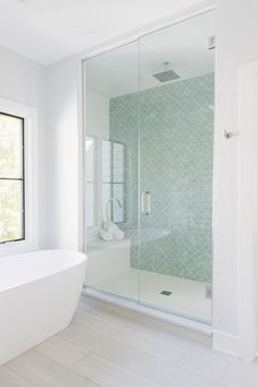 a white bath tub sitting next to a window