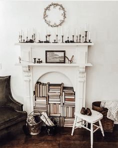 a living room with a fireplace, chair and bookshelf