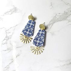 Blue Azulejo Earrings: These delicate blue and white mosaic tile earrings are handcrafted from polymer clay.  The clay is hand colored and painted to give it a beautiful Azulejo tile appearance.  The earring posts are nickel free, gold plated brass to compliment the handmade clay tile charms.  I have paired these stunning ear wires and clay with beautiful brass charms.  These hang right at 2.5 inches from the ear lobe, are nickel free, and sealed to protect from daily wear and tear.  These are h Bohemian Blue Polymer Clay Earrings, Blue And White Mosaic Tile, White Mosaic Tile, Mosaic Earrings, Tile Earrings, White Mosaic, Blue Mosaic, Resin Clay, Clay Tiles