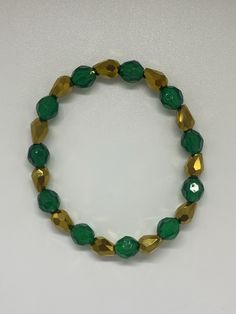 Material: Clear String Color: Green and Gold Type: Bracelet Style: Glamorous Cheap Green Holiday Bracelets, Green Bracelet, Gold And Green, Bracelet Style, Classic Elegance, Fashion Bracelets, Green And Gold, Timeless Pieces, Gold Bracelet