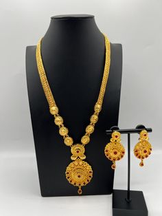 Embrace regal elegance with our exquisite 24K gold-plated Rani Haar set, a true masterpiece designed for the modern queen. This luxurious jewelry set, inspired by traditional royal designs, is perfect for weddings, special occasions, or adding a touch of grandeur to your collection. Care Instructions: To maintain the pristine condition of your Rani Haar set, avoid direct contact with water, perfumes, and harsh chemicals. Store in a dry, cool place when not in use. Luxury Gold Plated Temple Necklace For Ceremonial Occasions, Luxury 22k Gold Temple Bridal Necklace, Luxury Temple Jewelry Tikka As Gift, Luxury Gold Temple Necklace With Peacock Design, Luxury Ornate Hallmarked Temple Necklace, Luxury Fusion Temple Necklace For Gift, Luxury Fusion Temple Necklace Gift, Luxury Fusion Temple Necklace As Gift, Luxury 22k Gold Spiritual Temple Necklace