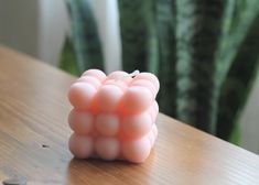 a small pink object sitting on top of a wooden table